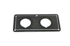Black metal plate with two circular holes on a white background